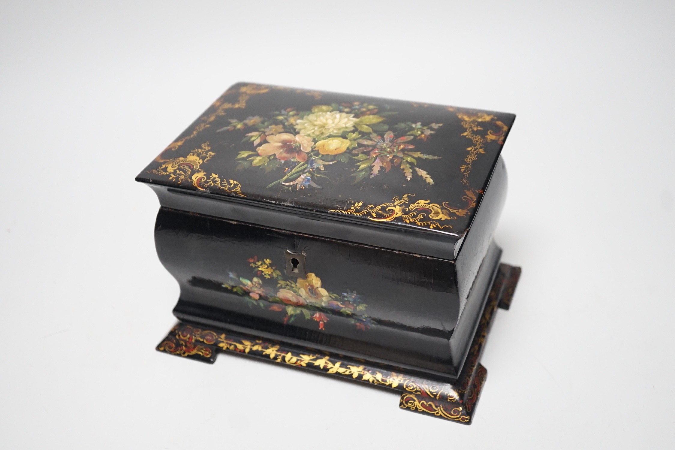 A Victorian papier-mâché bombé tea caddy with painted floral and gilt decoration. 12.5cm high